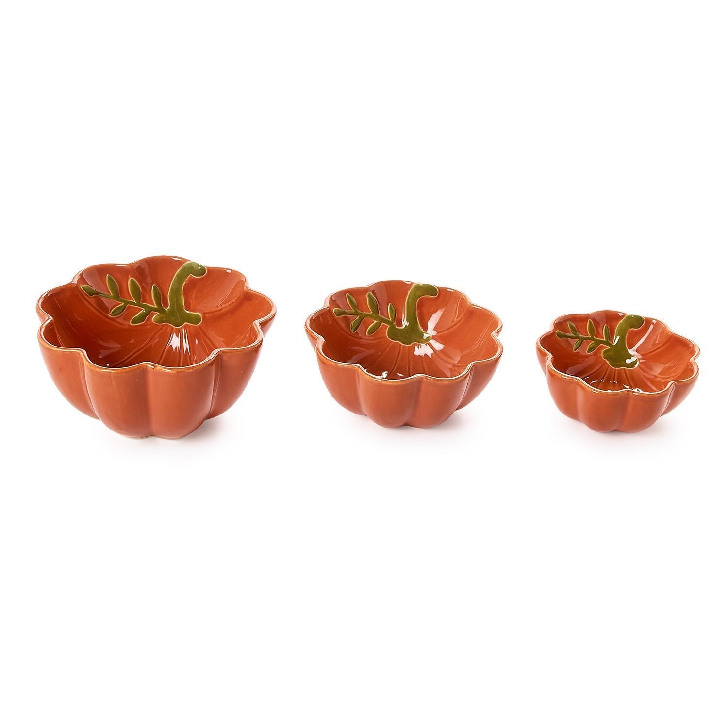 Three pumpkin-shaped bowls with leaf designs on a white background