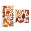 Two decorative paper napkins with autumn leaf patterns on a white background