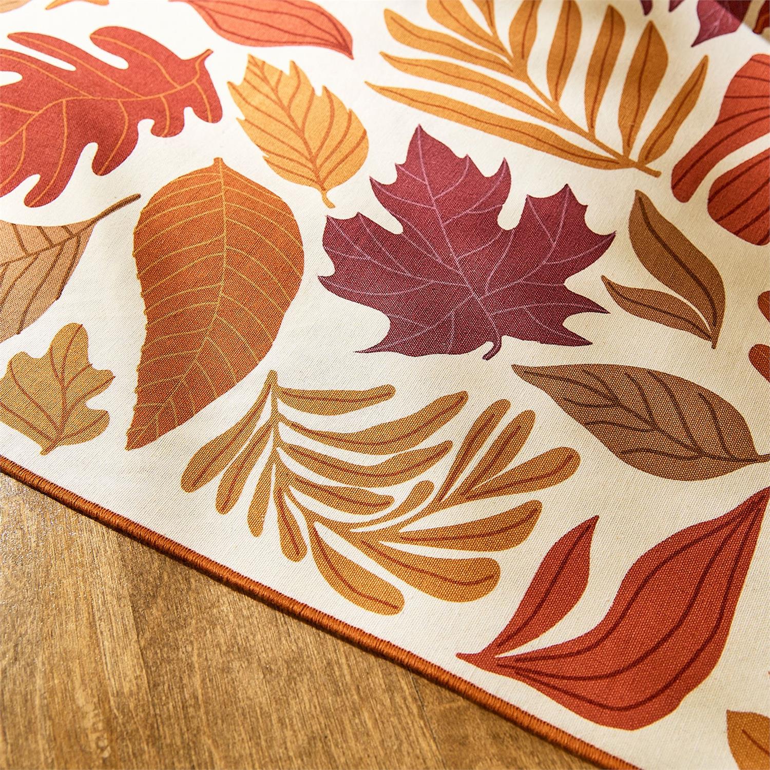 Autumn leaf patterned table runner on a wooden surface