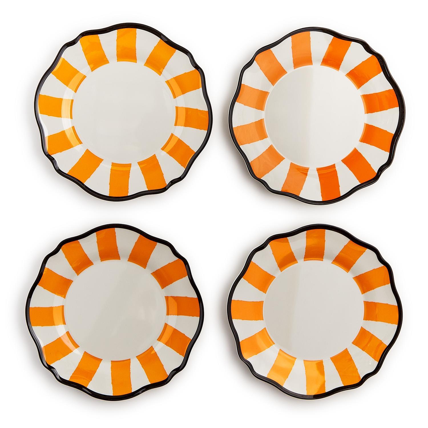 Four scalloped plates with orange and white striped design on a white background