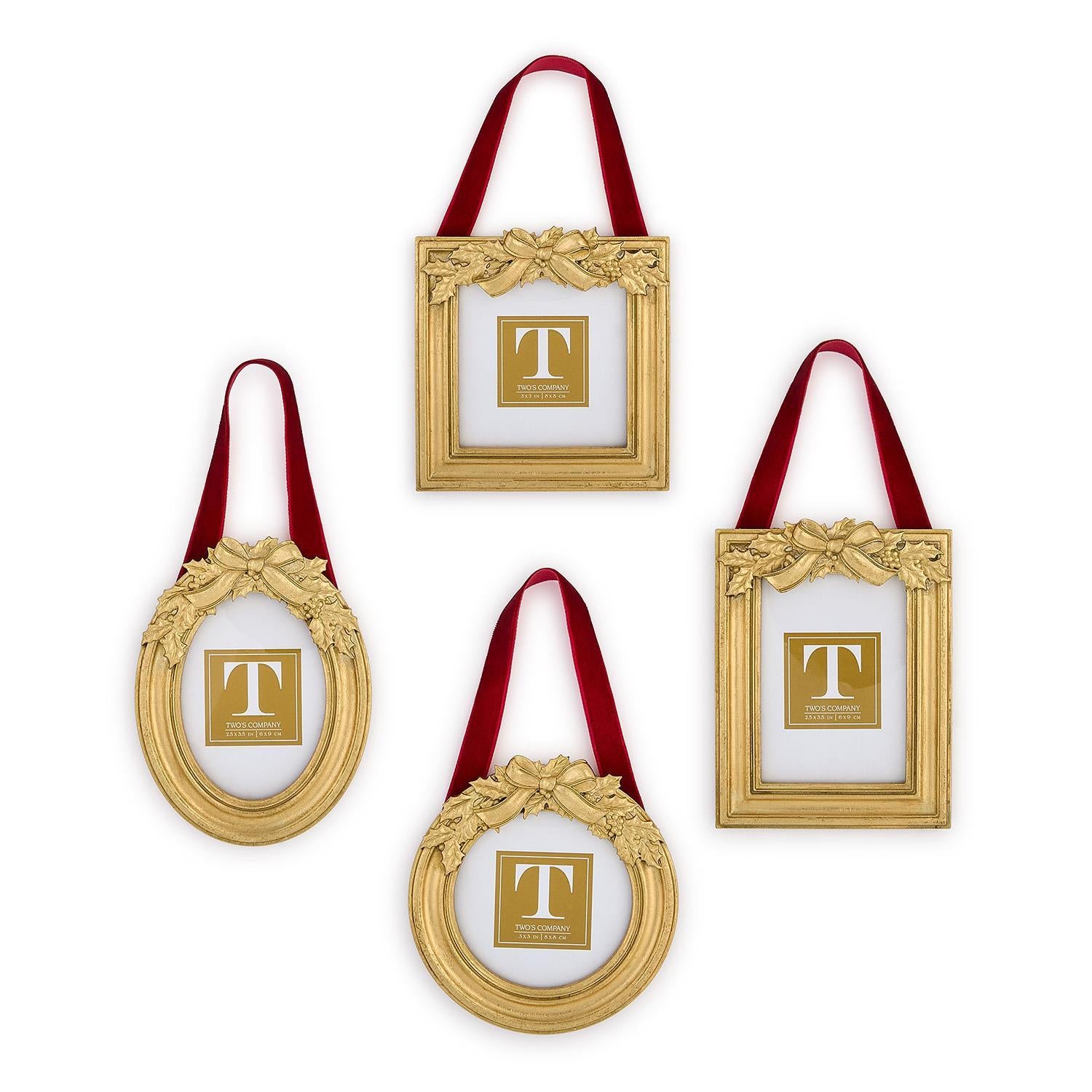 Set of gold picture frames with red ribbons and holly leave embellishments on a white background