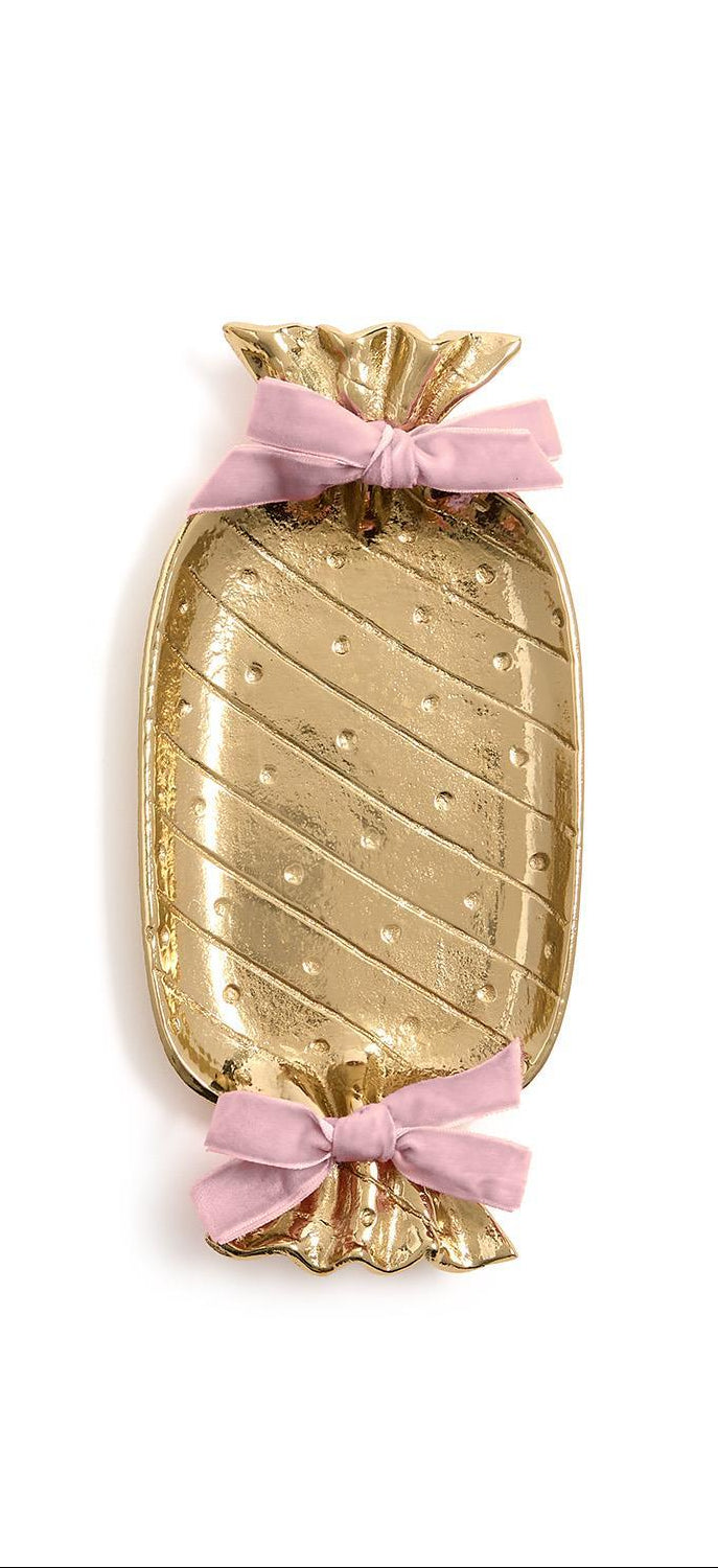 Gold candy-shaped tray with pink ribbons on a white background