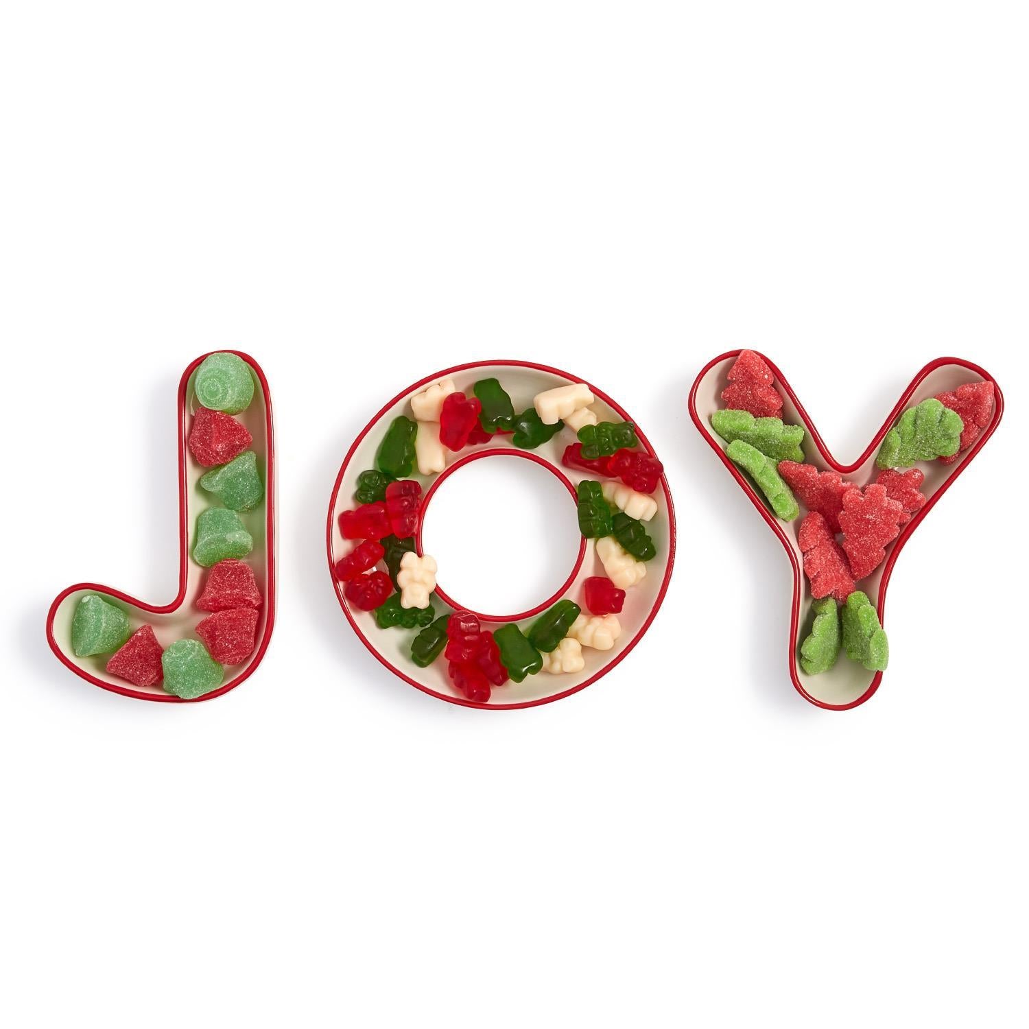 Decorative letters spelling 'JOY' filled with candy on a white background