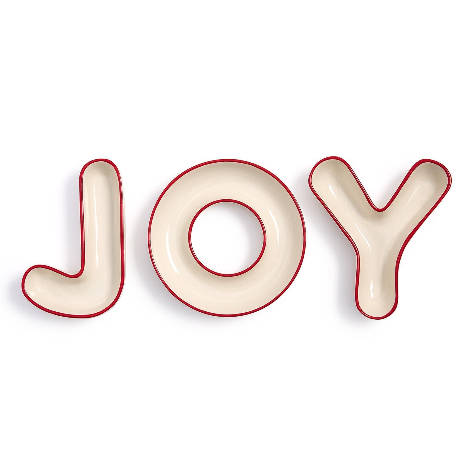 Decorative dishes spelling the word 'JOY' with red edges on a white background