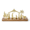 Gold nativity scene on a wooden base with a white background