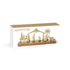 Nativity set with wooden stand and gold figures in packaging on a white background