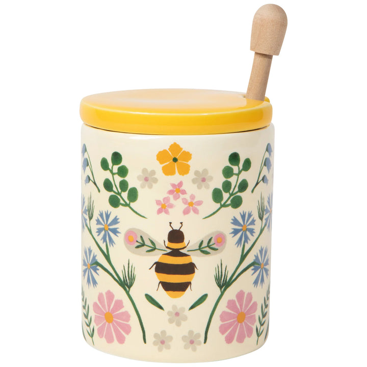 Decorative honey jar with floral design and bee illustration on a white background
