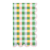 Checkered napkin with scalloped edge in green, yellow, and pink on a white background