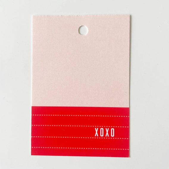 Card with a red stripe and 'XOXO' text on a beige background
