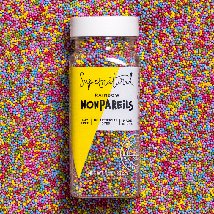 Supernatural Rainbow Nonpareils candy jar on a colorful background