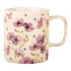 Ceramic mug with purple floral design on a white background