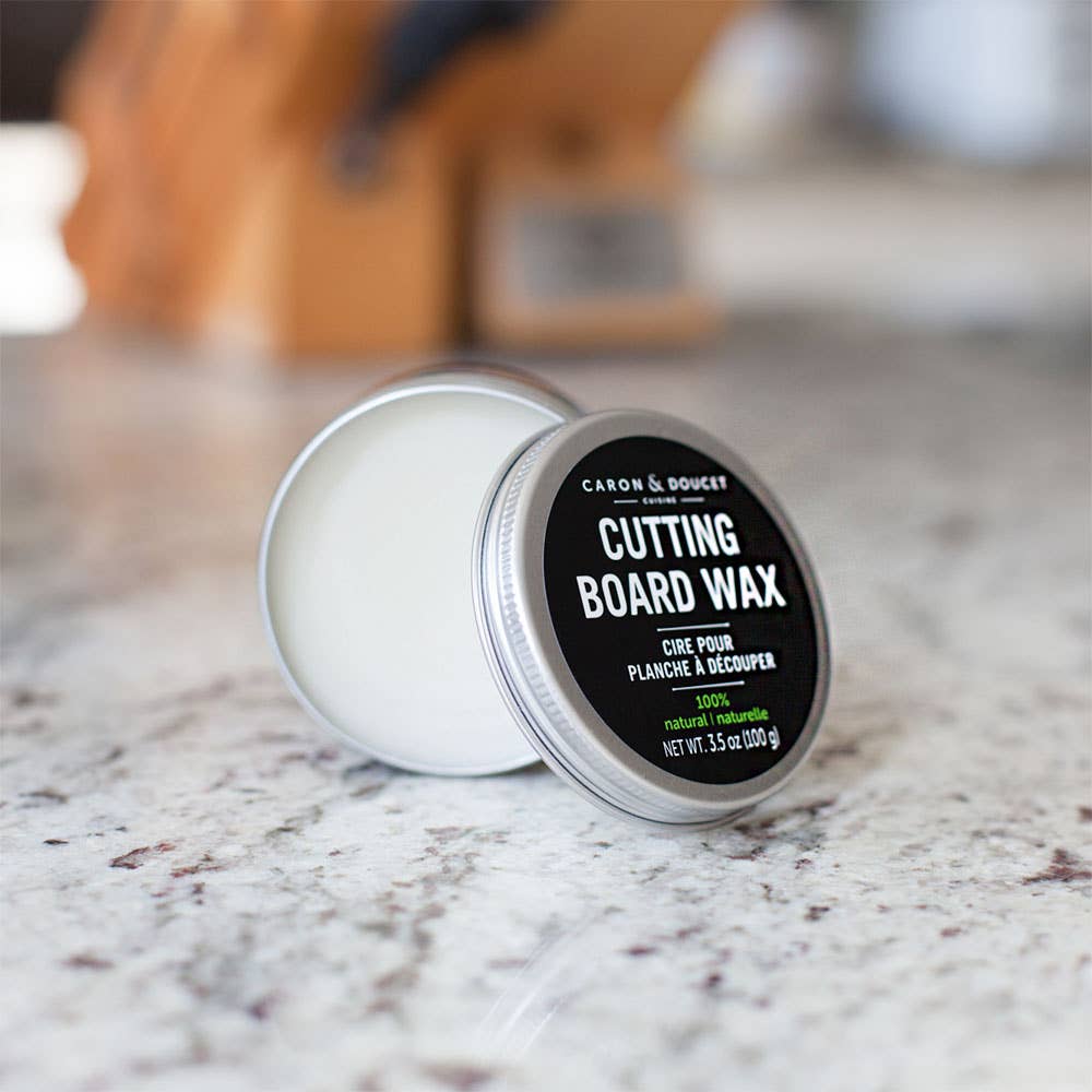 Tin of cutting board wax on a marble surface