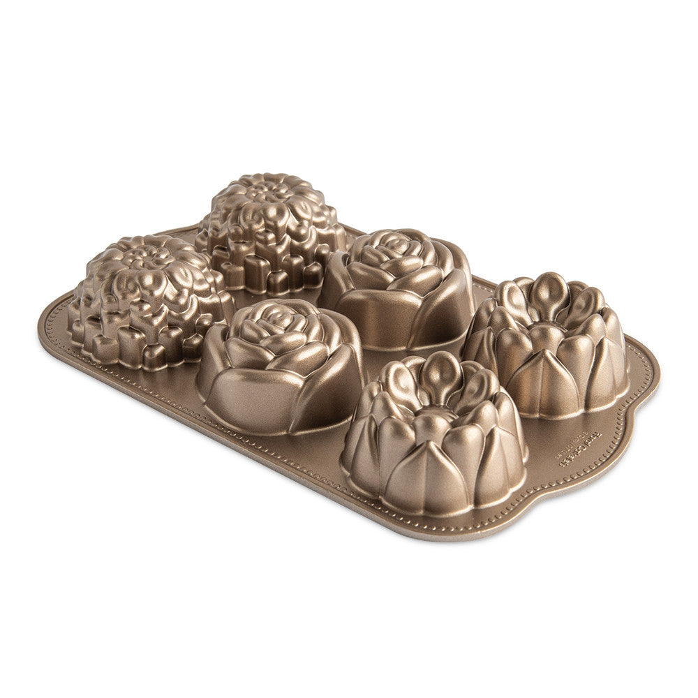 Bronze colored floral cake mold on a white background