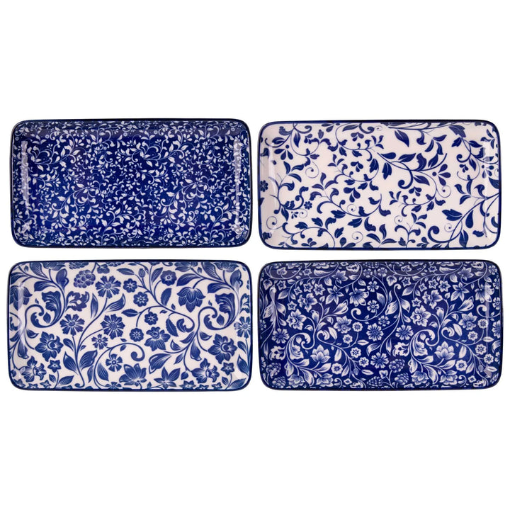 Set of four blue and white patterned trays on a white background