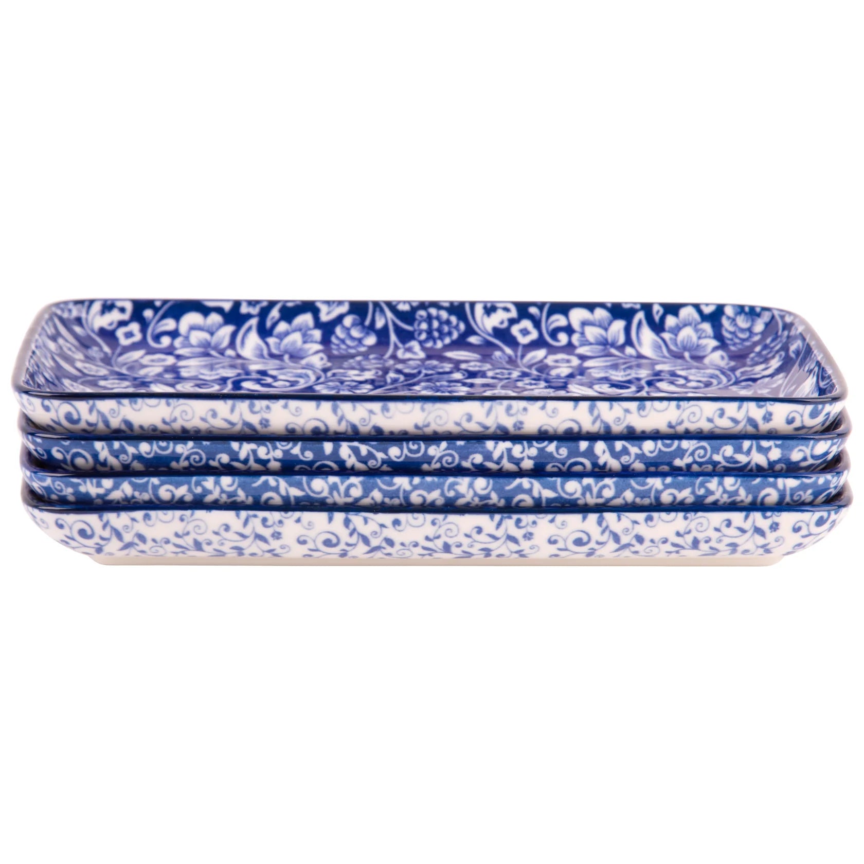 Set of four blue and white patterned platters on a white background
