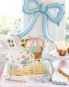 Pastel Easter-themed decor with bunny cookies, a basket, and balloons.