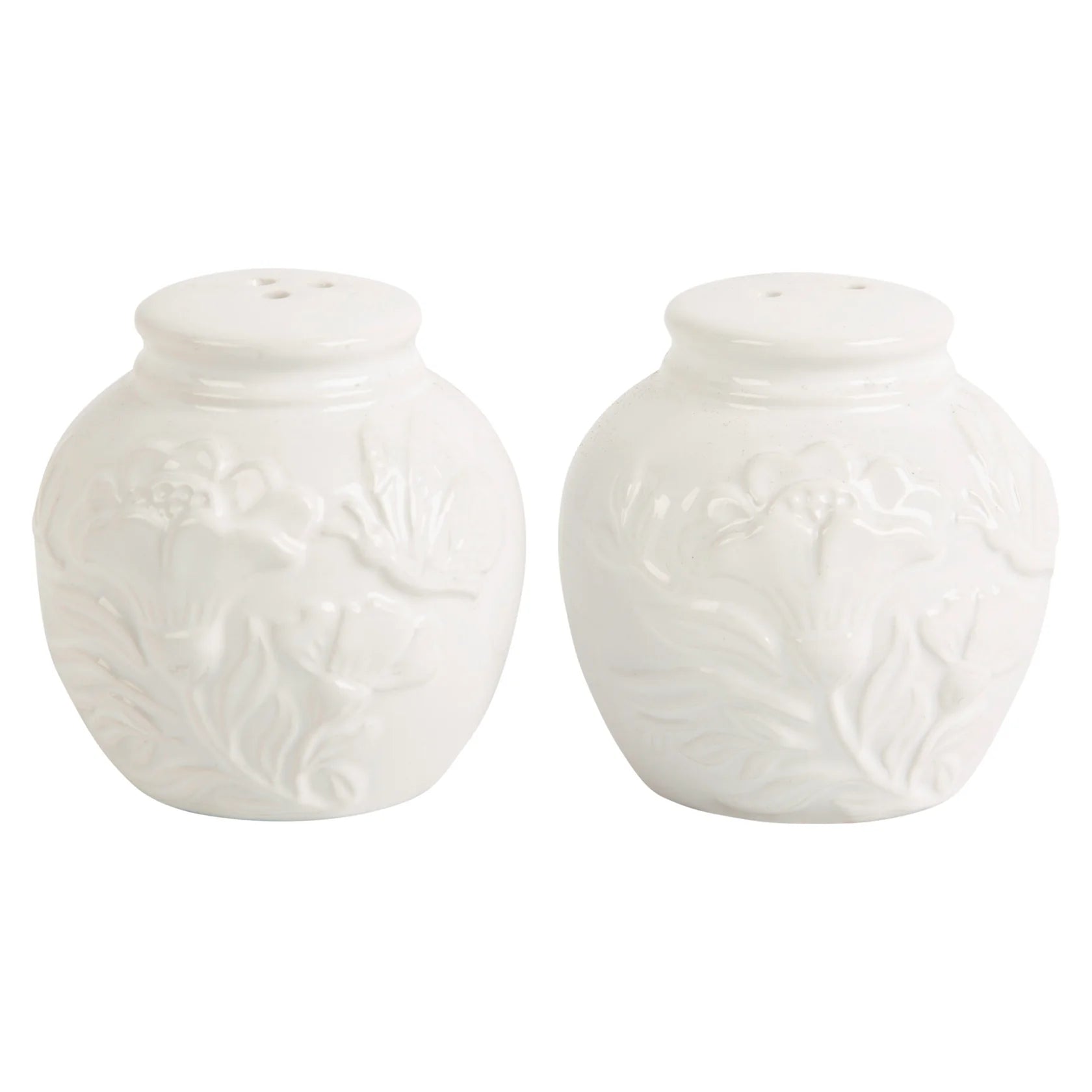 Two white salt and pepper shakers with floral pattern on a white background