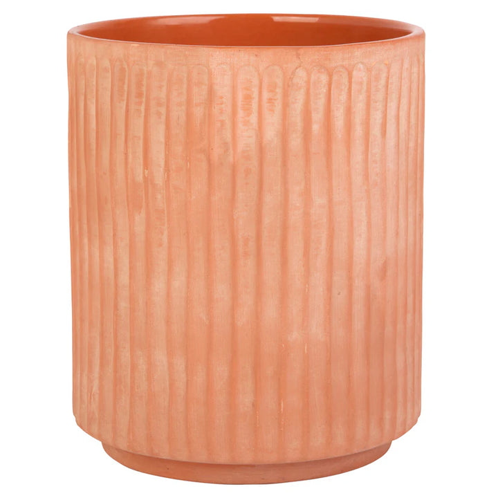 Terracotta-colored utensil crock with ribbed texture on a white background