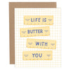Card with yellow labels reading 'Life is butter with you' on a grid background