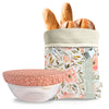 Floral-patterned bread bag with bread loaves and a matching pink polka dot bowl cover on a white background