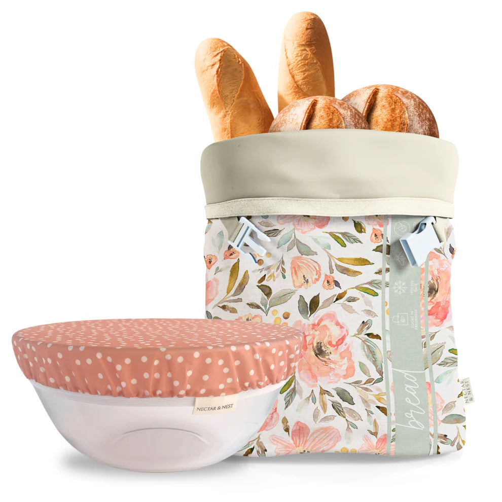 Floral-patterned bread bag with bread loaves and a matching pink polka dot bowl cover on a white background
