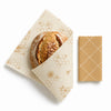 Wax wrap with bread and a block of beeswax on a white background
