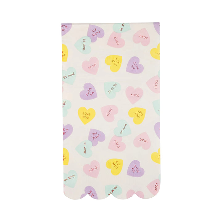 Paper napkin with pastel conversation hearts on a white background