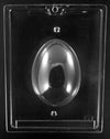 A clear egg shaped chocolate mold on a black background.