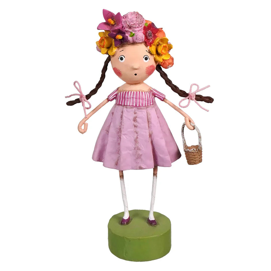 Decorative figurine with a floral headpiece and pink dress on a white background