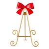 Gold decorative easel with a red bow on a white background