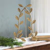 Gold leaf decorative easel on a table  with a neutral background