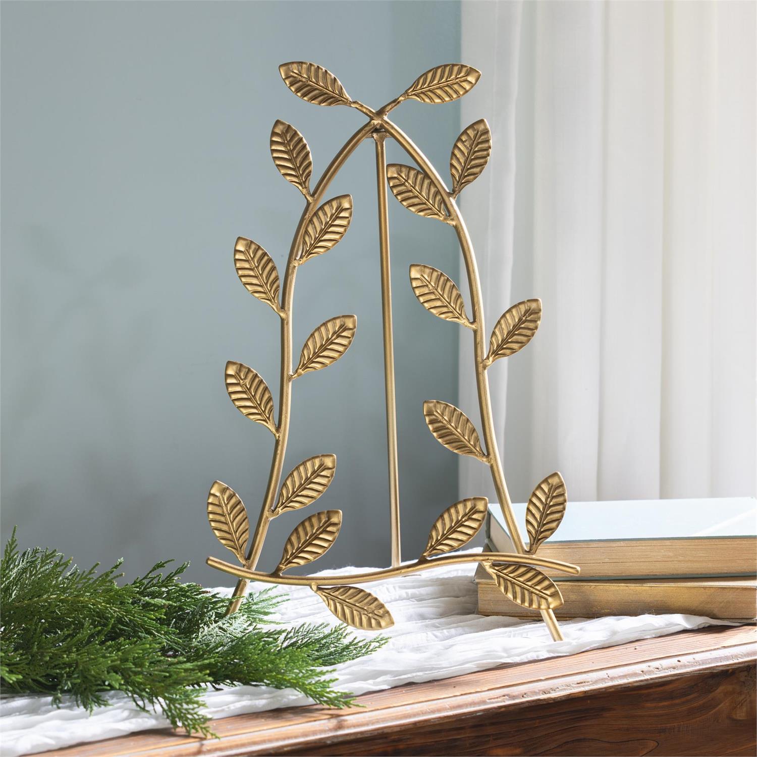 Gold leaf decorative easel on a table  with a neutral background