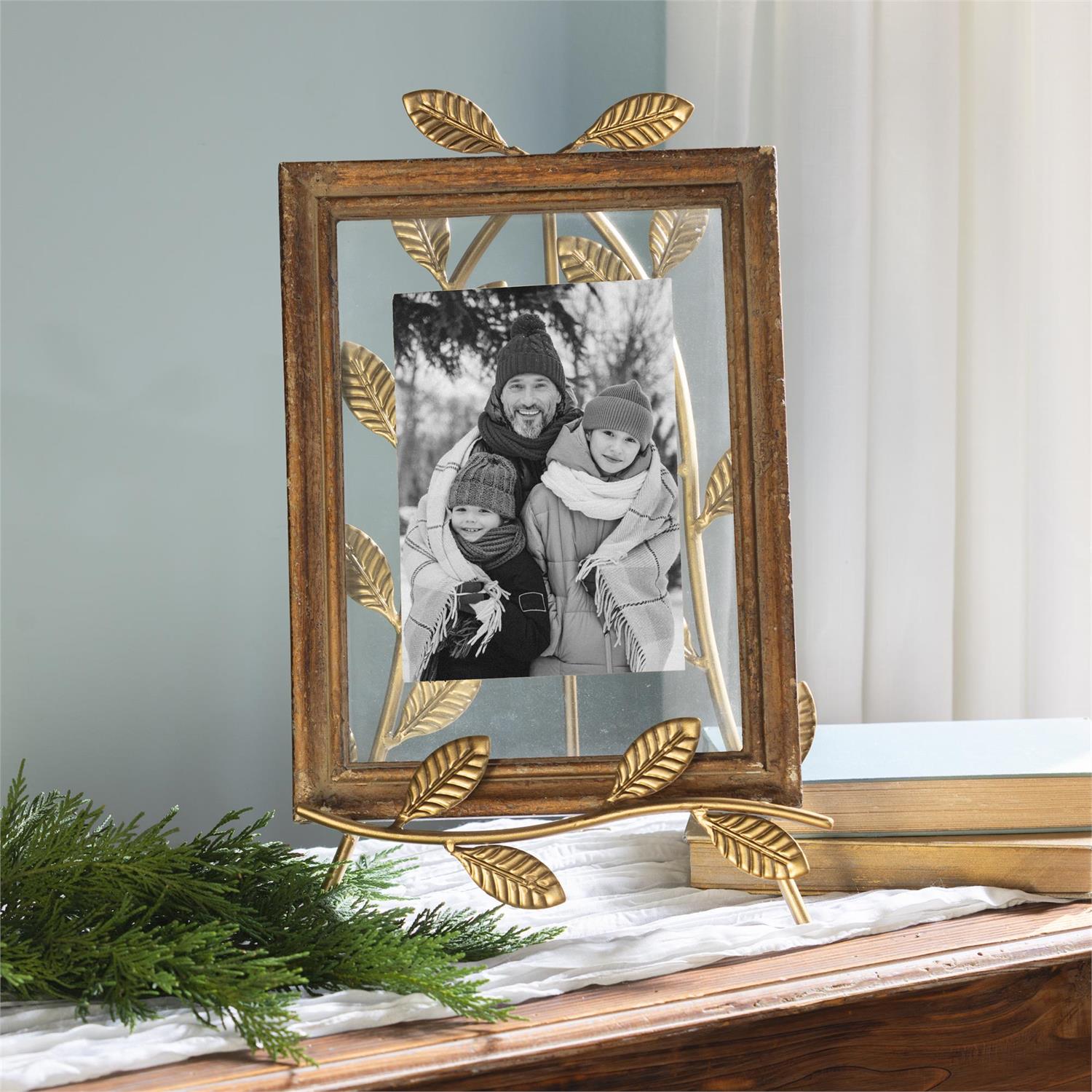 Decorative photo frame on a  gold leaf easel with a blurred background