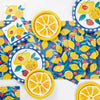 Colorful tableware set with lemon and strawberry design on a blue checkered background