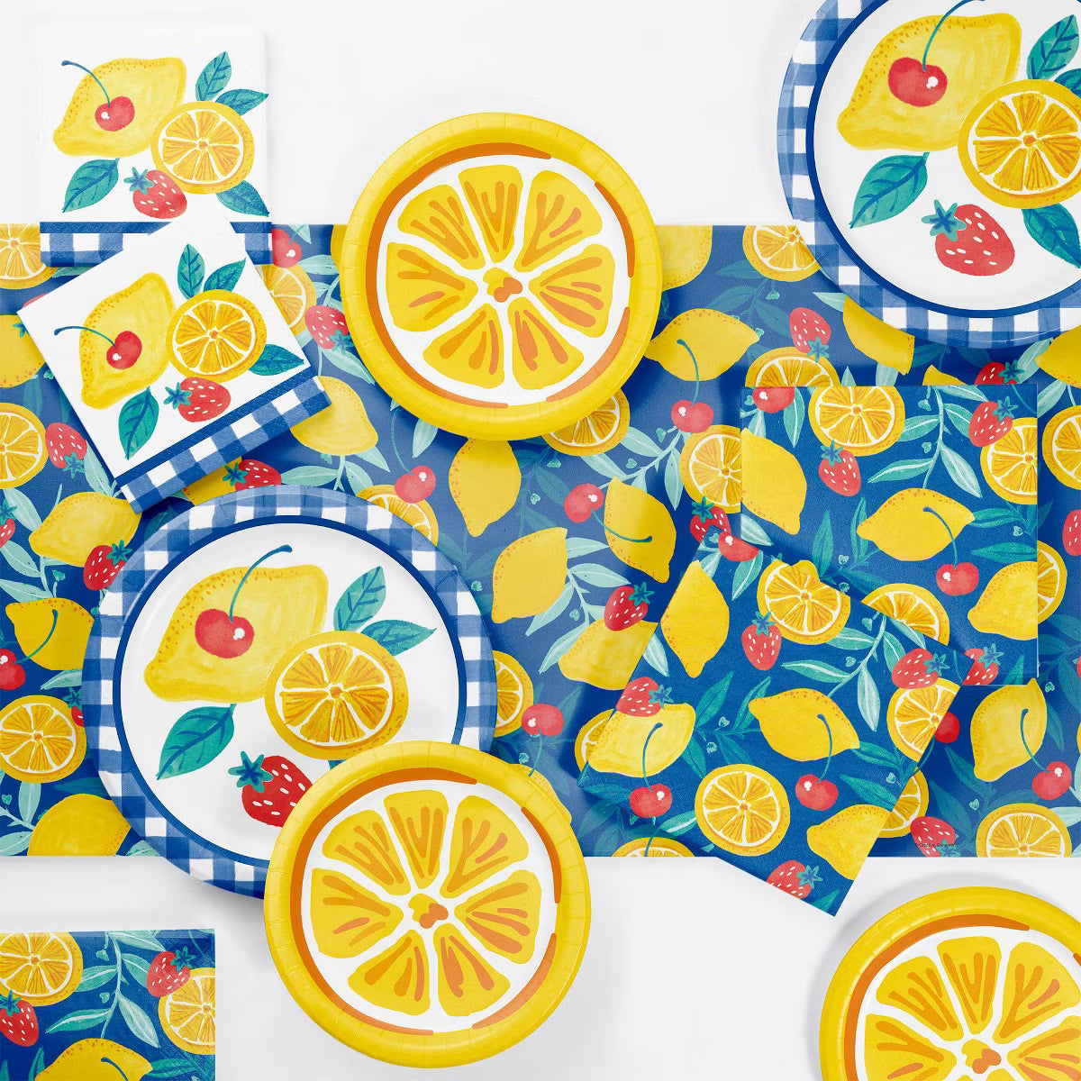 Colorful tableware set with lemon and strawberry design on a blue checkered background