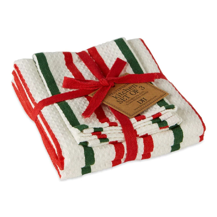 A set of three kitchen towels with holiday stripes, tied together with a red twill ribbon and a tag.