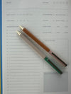 Two pens on a recipe card with checkboxes and text.