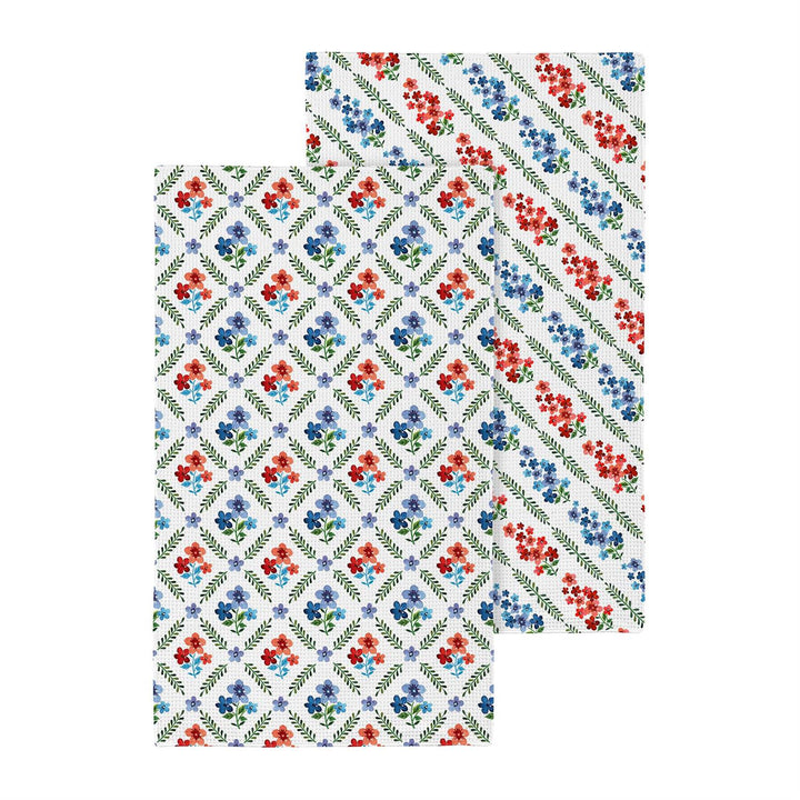 Double sided floral patterned towel on a white background