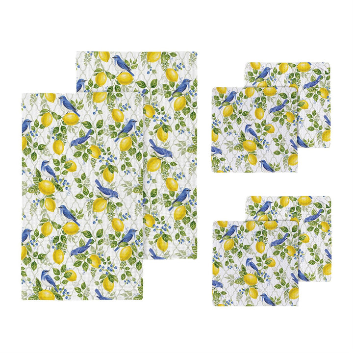 Set of kitchen towels and dish cloths with lemon and blue bird pattern on a white background