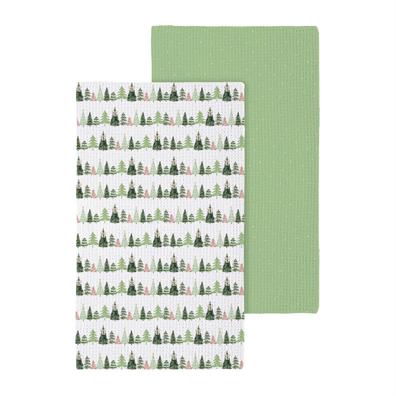 Two kitchen towels, one with a forest pattern and one solid green, on a white background.
