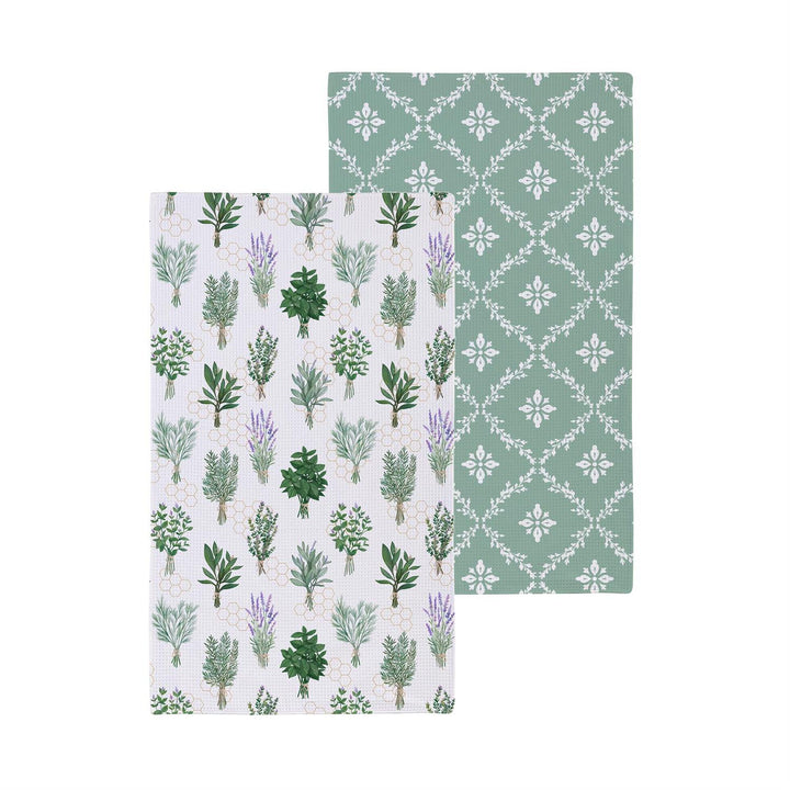 Two patterned towels with botanical designs on a white background