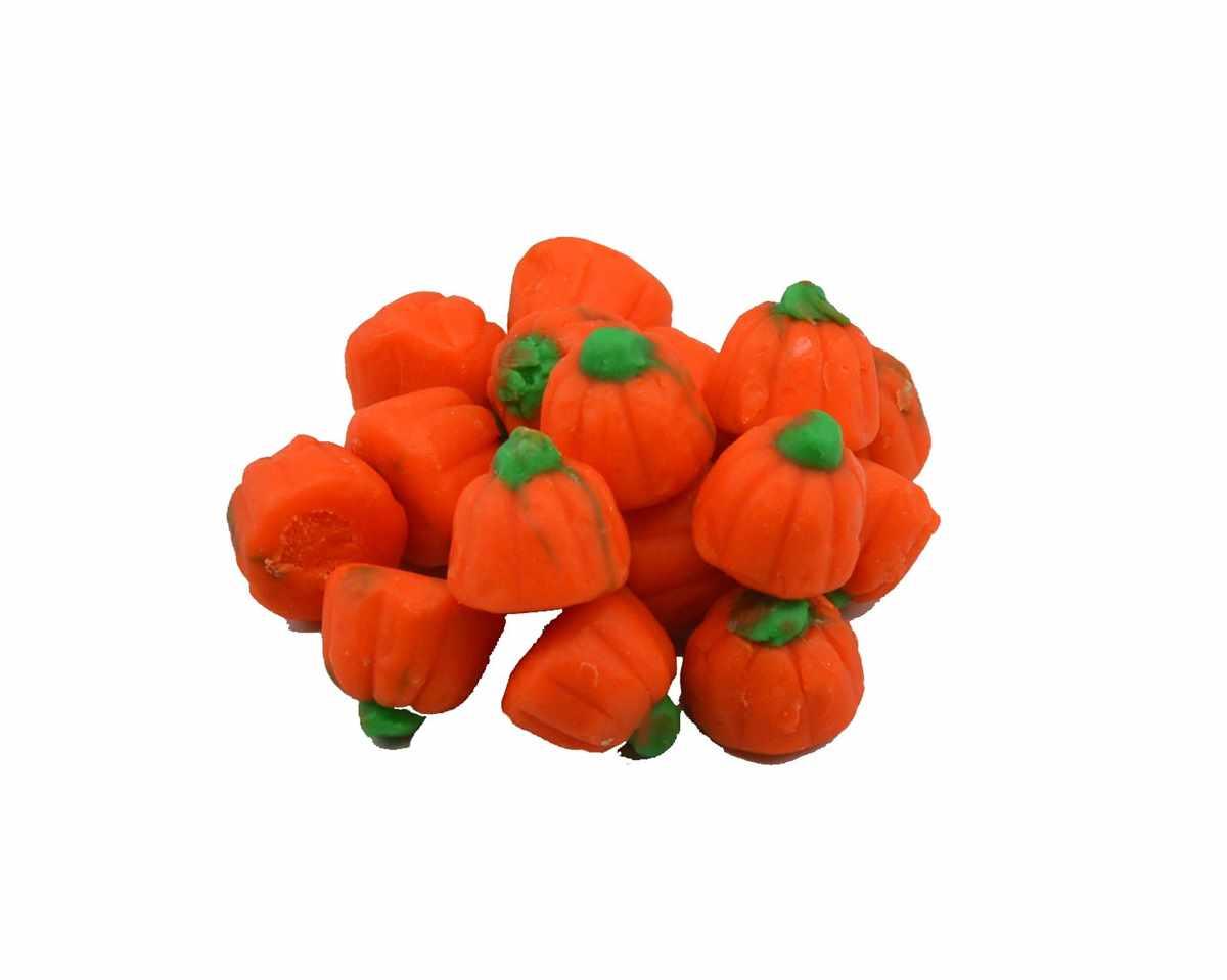 Orange pumpkin-shaped candy with green stems on a white background