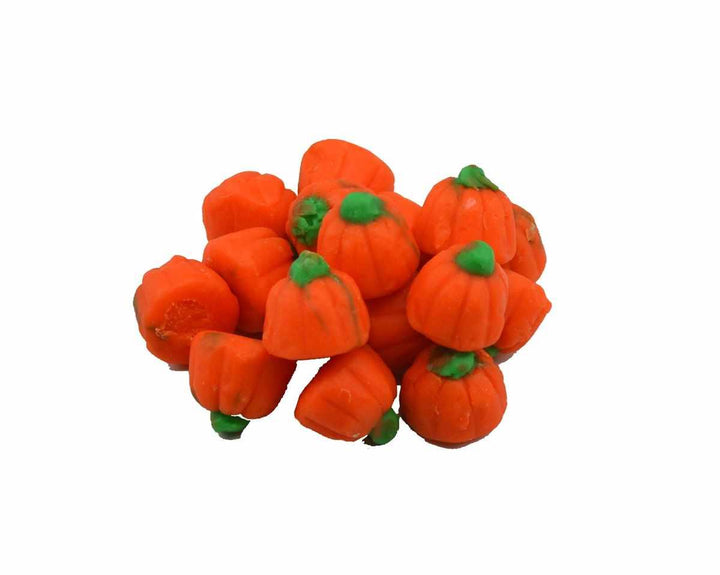 Orange pumpkin-shaped candy with green stems on a white background