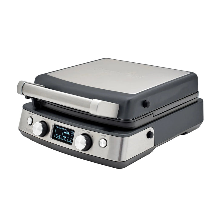 Black and silver waffle maker with digital display on a white background.