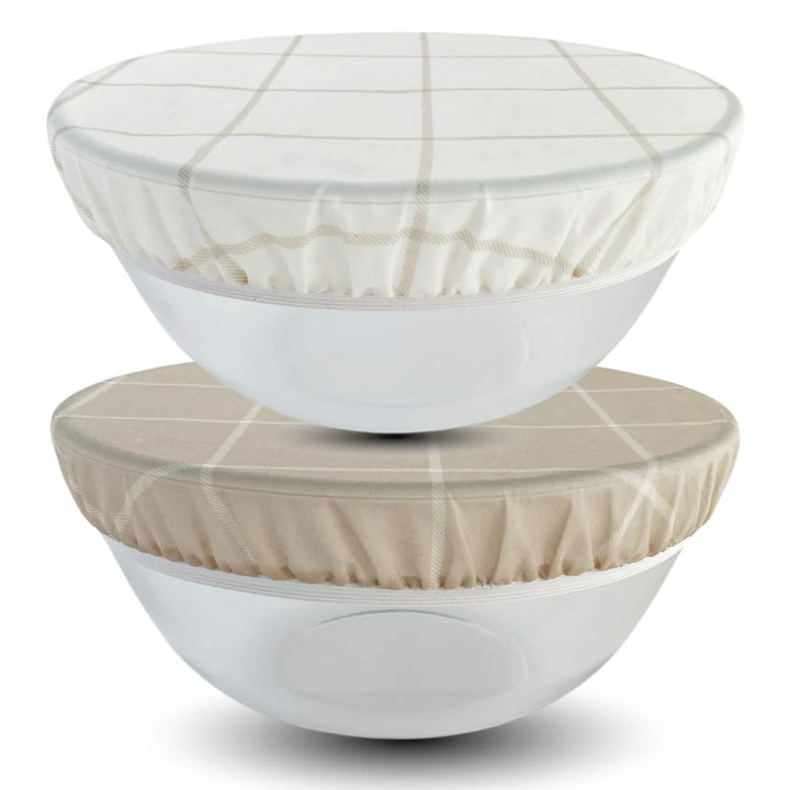 Two white bowls with fabric beeswax bowl covers on a white background