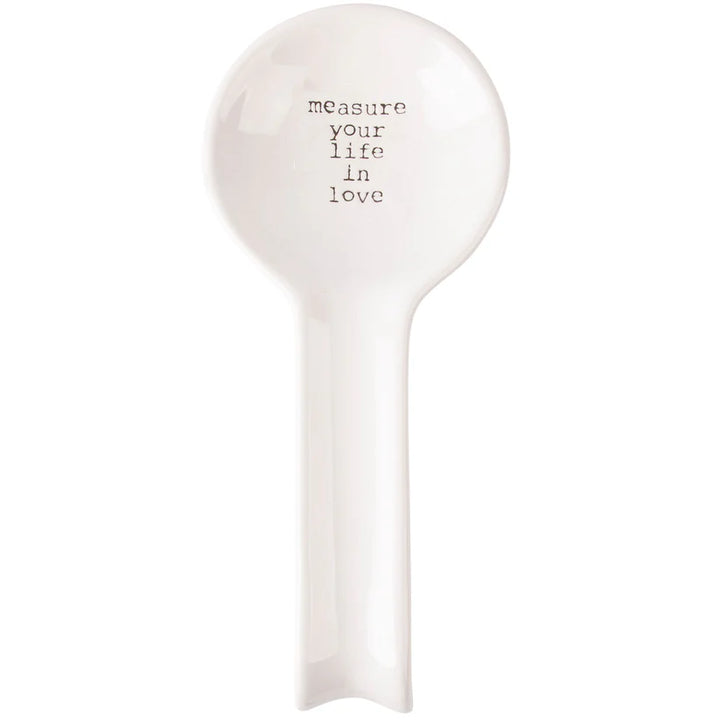 White ceramic spoon rest with text on a white background
