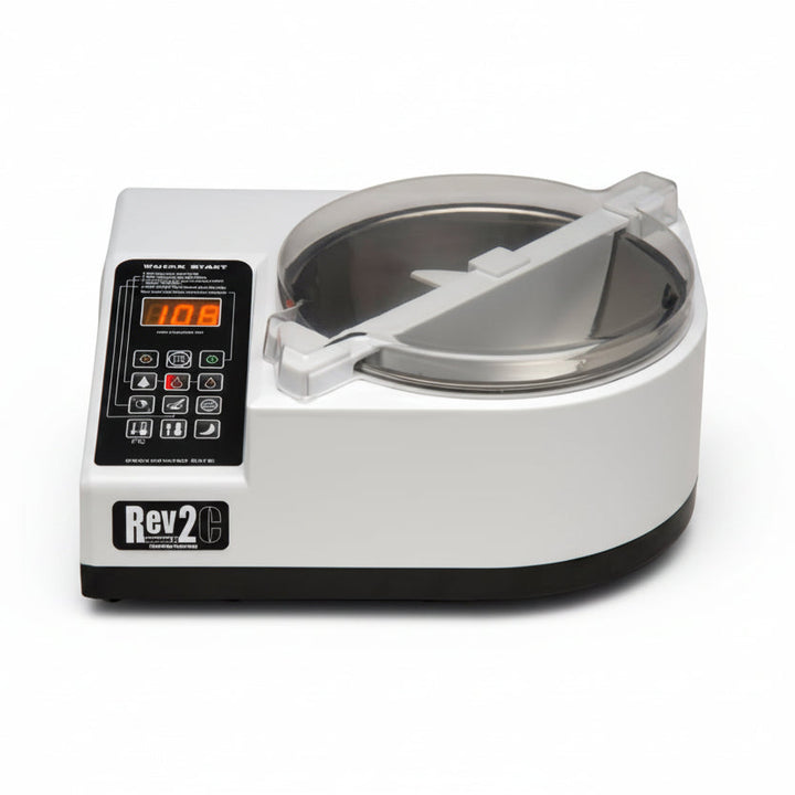 A white and black Revolation 2 chocolate tempering machine with a clear lid, shown on a solid white background.