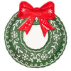 Decorative plate shaped like a Christmas wreath with a red bow on a white background