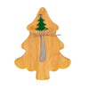 Wooden Christmas tree-shaped cheese board with a knife and decorative elements on a white background