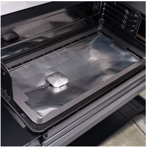 Grill with a silver rectangular tray in the bottom.